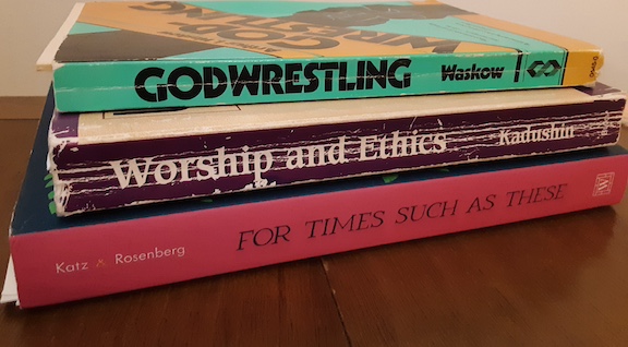 stack of three paper-back books -- God-Wrestling, Worship and Ethics, and For Times Such as These -- showing loose pages and wear