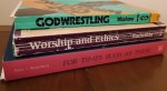 stack of three paper-back books -- God-Wrestling, Worship and Ethics, and For Times Such as These -- showing loose pages and wear